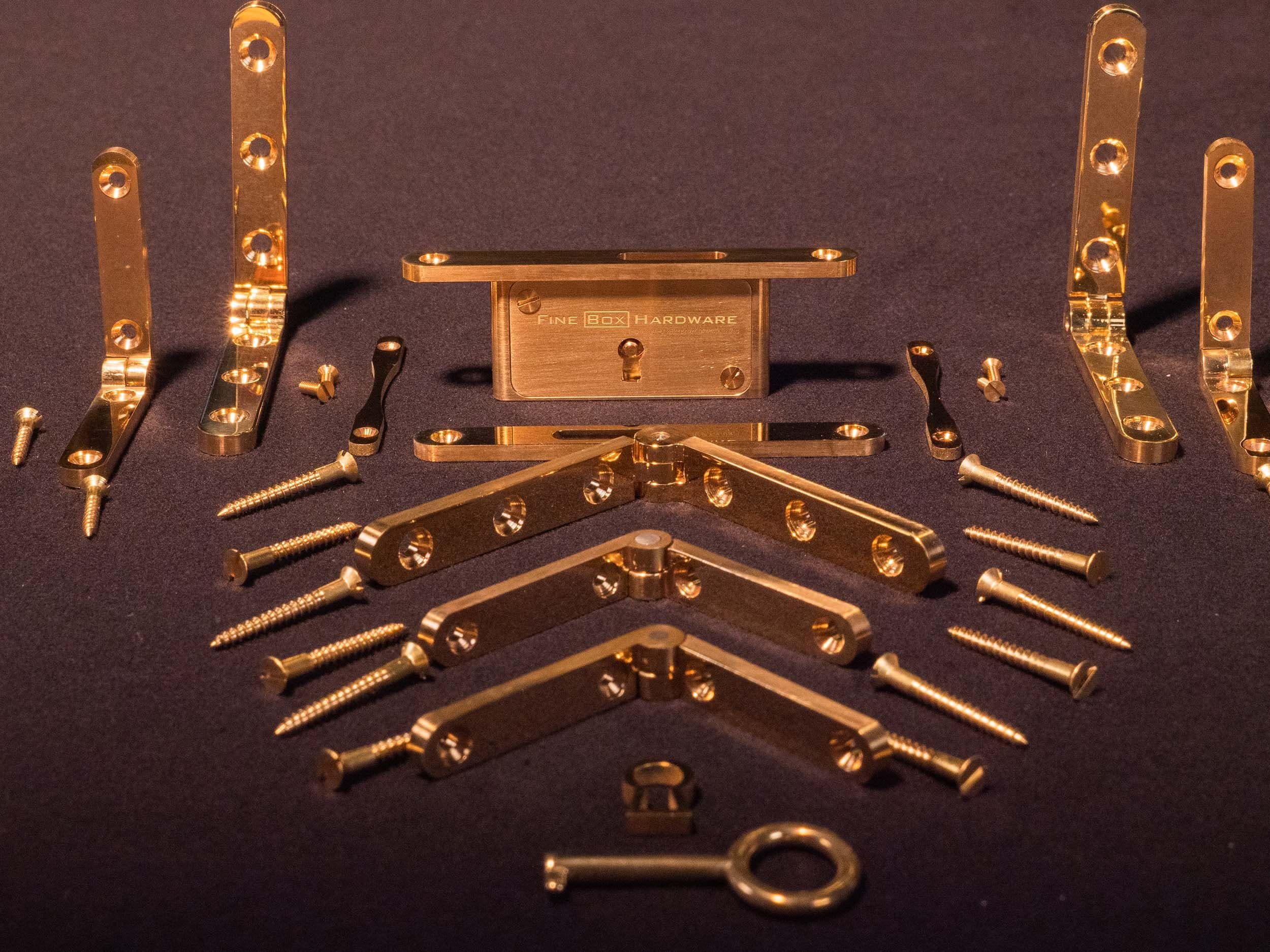Solid brass precision hardware set: lock, hinges, escutcheons, key, and tray handles