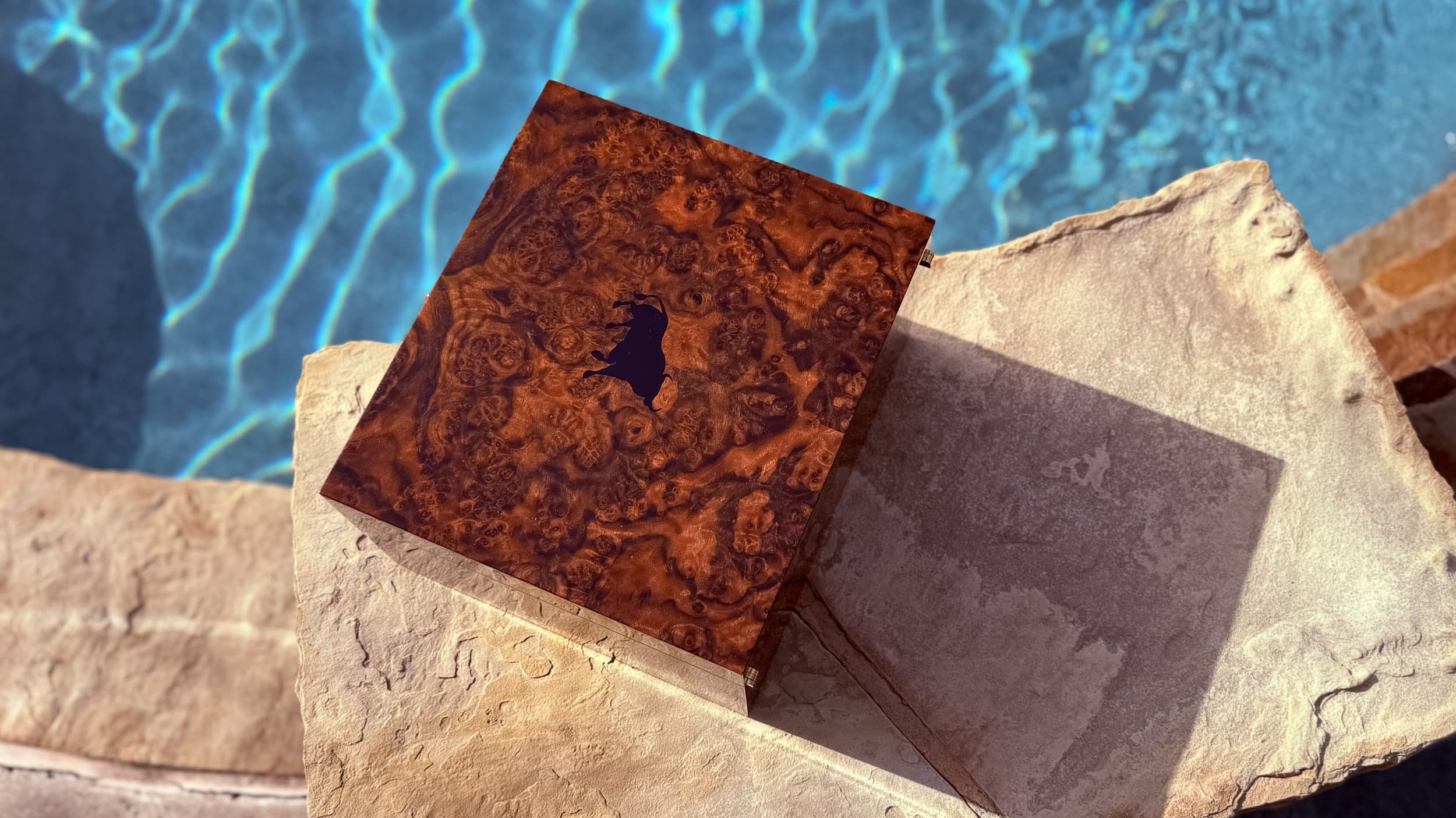 The Toro: centient luxury walnut burl humidor lid bull silhouette top view
