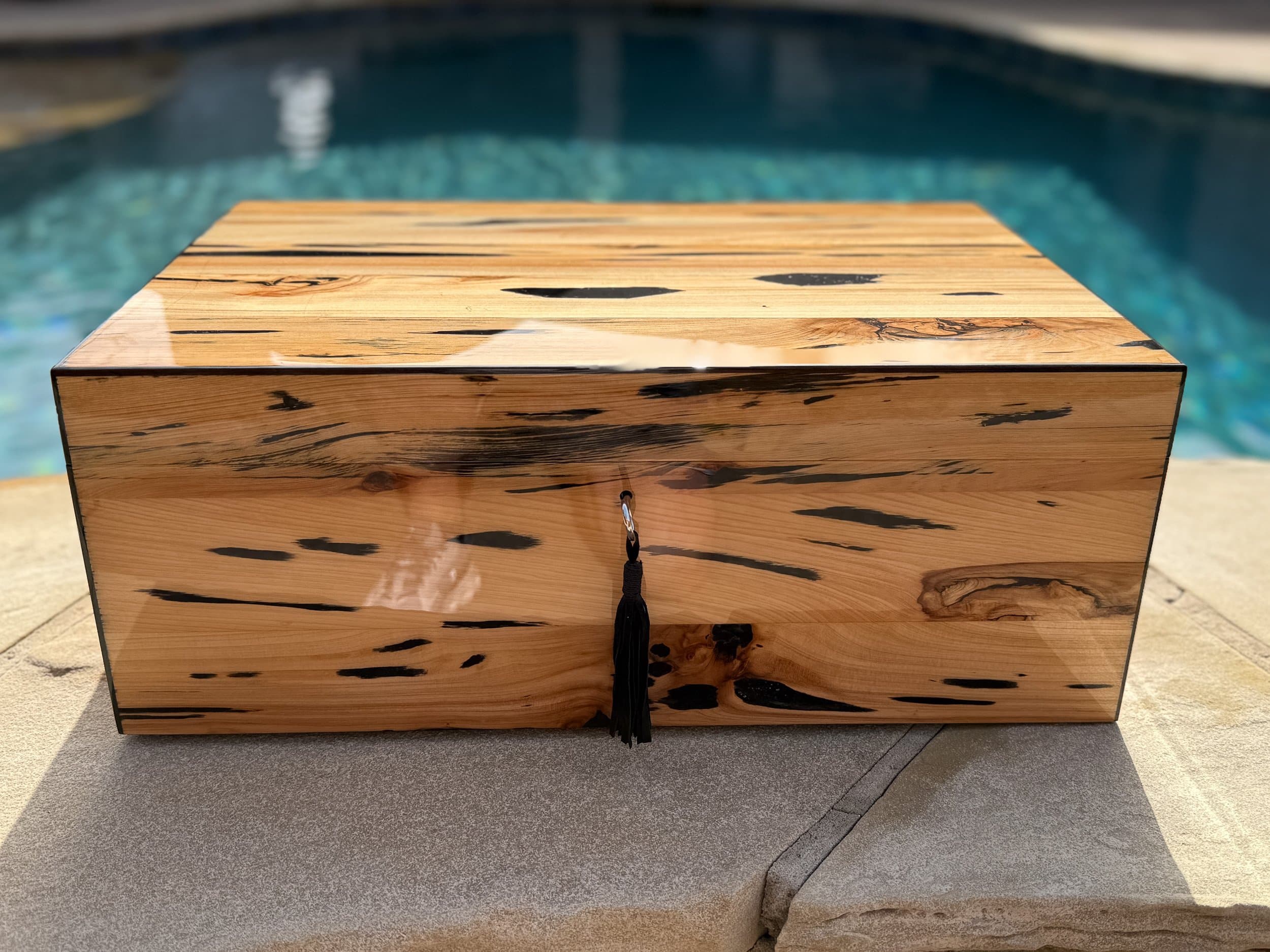 The Cypress — Blackline: centient luxury pecky cypress humidor poolside front