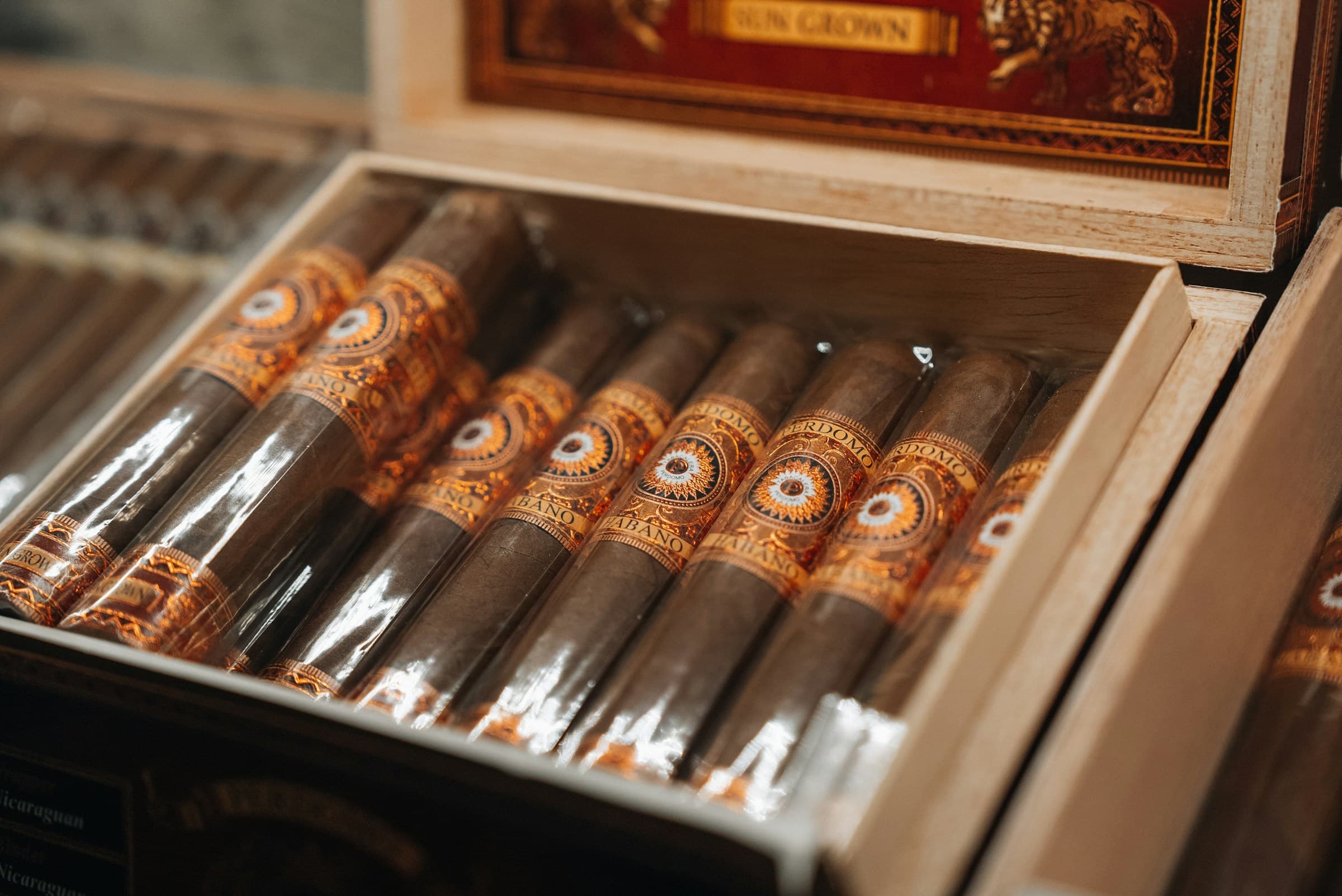 An open box of cigars at rest on a table.